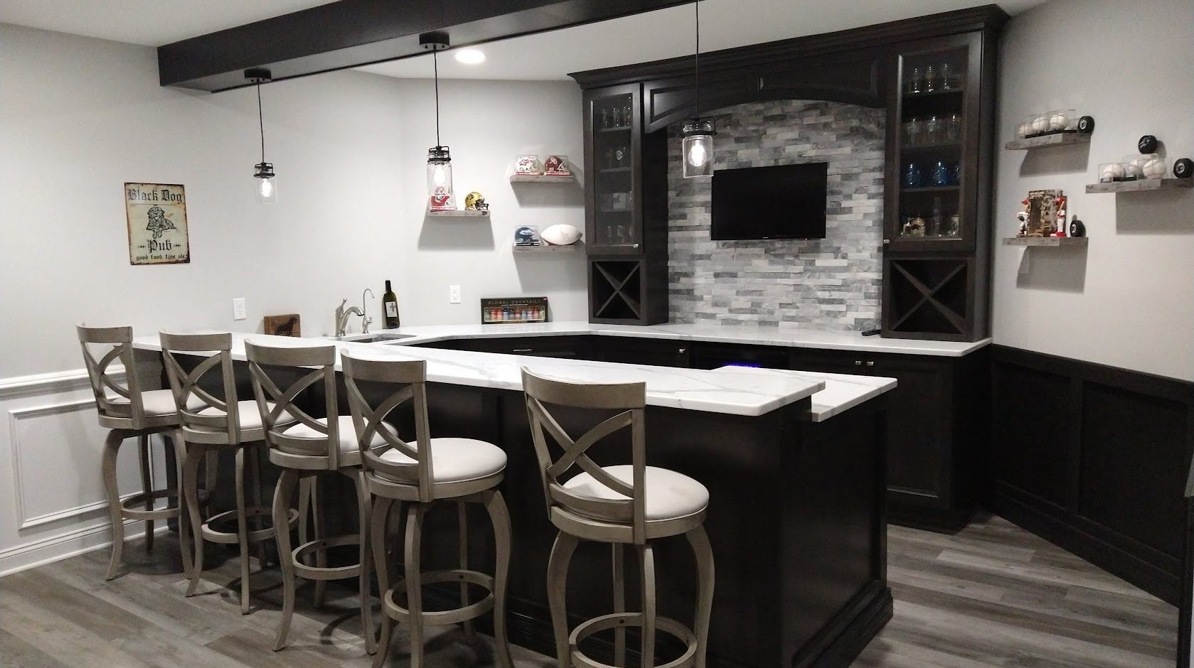 Bright modern kitchen with white cabinetry, marble island, and stainless steel appliances.